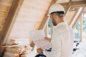 man architect studies documentation or blueprints